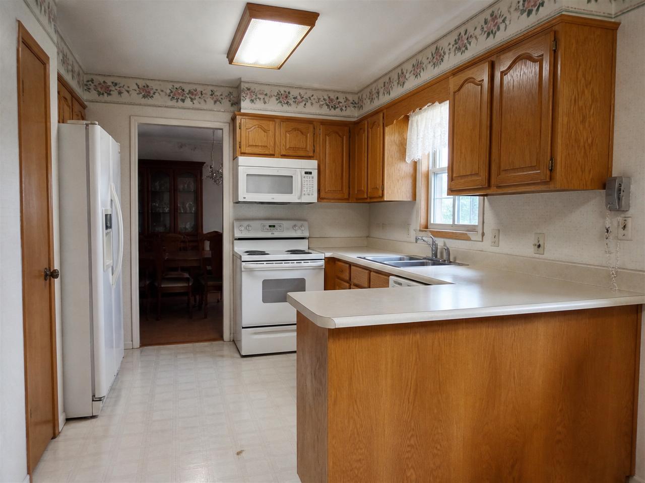 Before — Two-tone transitional kitchen with walnut island